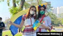 Valeriia Golovakhina, a Ukrainian (left), attends an anti-war protest in Bangkok, Thailand on February 27, 2022