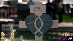 Messages are written on a cross honoring Irma Garcia, a teacher who was killed in the May 24 elementary school shooting in Uvalde, Texas, in this photo taken on May 26, 2022.