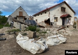 Packs with the bodies of Russian soldiers found and exhumed in a mass grave are seen in the village of Mala Rohan after it was retaken by the Ukrainian Armed forces, in Kharkiv region, Ukraine, May 19, 2022.