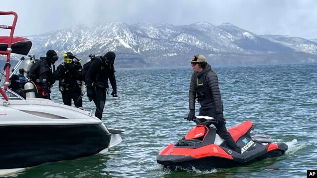 Divers prepare to enter the water at the end of the year-long Lake Tahoe cleanup in Stateline, Nev., May 10, 2022.