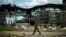 FILE - A Ukrainian serviceman walks past a gypsum manufacturing plant destroyed in a Russian bombing in Bakhmut in eastern Ukraine, May 28, 2022.