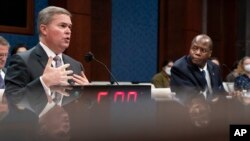 Deputy Director of Naval Intelligence Scott Bray, left, and Under Secretary of Defense for Intelligence and Security Ronald Moultrie, speak during a hearing on "Unidentified Aerial Phenomena," on Capitol Hill, May 17, 2022.