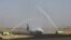 A Yemen Airways plane is greeted with water canon salute at Sanaa Airport as the first commercial flight in around six years, in Sanaa, Yemen, May 16, 2022.