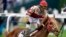 Sonny Leon celebrates after riding Rich Strike past the finish line to win the 148th running of the Kentucky Derby horse race at Churchill Downs, May 7, 2022, in Louisville, Ky.