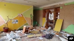 This April 24, 2022 photo provided by Inna Levchenko shows damage from Russian shelling to School No. 21, in Chernihiv, Ukraine. Levchenko opened the school as a shelter to hundreds of frightened families. Seventy children she’d ordered to shelter in the 