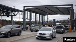 FILE - Vehicles drive pass the Nuijamaa border station between Finland and Russia in Lappeenranta, Finland, March 17, 2020. (Lehtikuva/Lauri Heino, via Reuters)