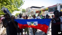 Demonstrators march demanding peace and security in La Plaine neighborhood of Port-au-Prince, Haiti, May 6, 2022. 