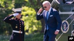 President Joe Biden returns a salute as he arrives at the White House from a weekend trip to his Delaware home, May 9, 2022, in Washington.