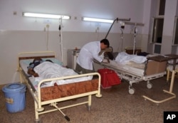 Wounded men receive treatment in a hospital, after a bombing in Mazar-e-Sharif, northern Afghanistan, May 25, 2022.