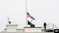 An American flag flies at half-staff at the White House, May 24, 2022, in Washington, to honor the victims of the mass shooting at Robb Elementary School in Uvalde, Texas.