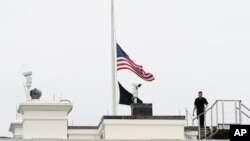 An American flag flies at half-staff at the White House, May 24, 2022, in Washington, to honor the victims of the mass shooting at Robb Elementary School in Uvalde, Texas.