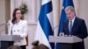 Finland's Prime Minister Sanna Marin (L) and Finland's President Sauli Niinisto give a press conference to announce that Finland will apply for NATO membership at the Presidential Palace in Helsinki, May 15, 2022. 