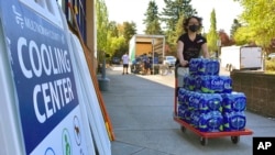 A volunteer helps set up snacks at a cooling center established to help vulnerable residents ride out the second dangerous heat wave to grip the Pacific Northwest this summer, on Aug. 11, 2021.