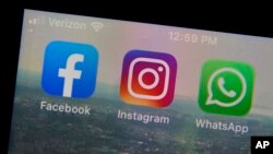 The mobile phone apps for, from left, Facebook, Instagram and WhatsApp are shown on a device in New York. (AP Photo/Richard Drew, File)