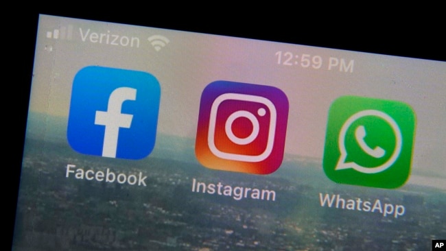 The mobile phone apps for, from left, Facebook, Instagram and WhatsApp are shown on a device in New York. (AP Photo/Richard Drew, File)