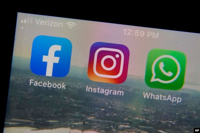 The mobile phone apps for, from left, Facebook, Instagram and WhatsApp are shown on a device in New York. (AP Photo/Richard Drew, File)