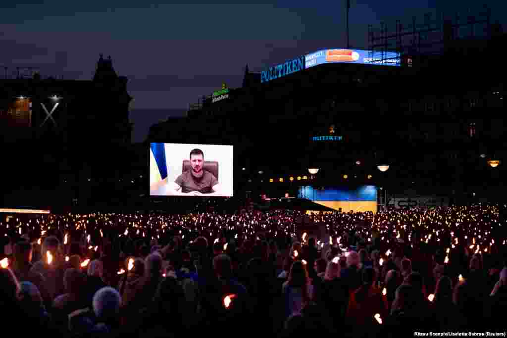 Ukrainian President Volodymyr Zelenskiy appears on screen to address people at the City Hall Square in Copenhagen, Denmark, May, 4, 2022.