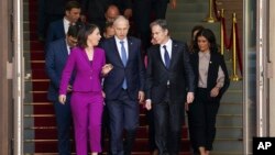 German Foreign Minister Annalena Baerbock, L, NATO Deputy Secretary General Mircea Geoana, 2nd L, and U.S. Secretary of State Antony Blinken, 2nd R, arrive for the group photo at the Informal Meeting of NATO Ministers of Foreign Affair in Berlin, Germany, May 15, 2022.