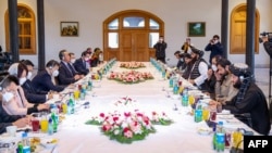 FILE - This handout photo released by the Taliban Foreign Ministry shows Taliban Foreign Minister Amir Khan Muttaqi, center-right, meeting with China's Foreign Minister Wang Yi, center-left, in Kabul on March 24, 2022