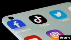 An illustration of Facebook, TikTok, Twitter, YouTube and Instagram apps are seen on a smartphone