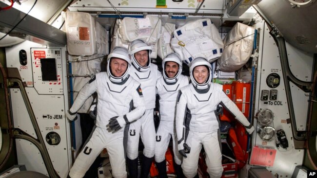 European Space Agency astronaut Matthias Maurer and NASA astronauts Tom Marshburn, Raja Chari and Kayla Barron pose for a photo in their spacesuits aboard the International Space Station's Harmony module on April 21, 2022. (NASA via AP)