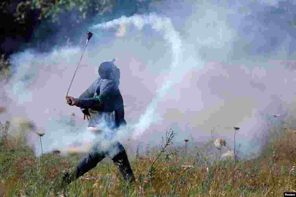 A demonstrator clashes with the Israeli forces following a rally marking the 74th anniversary of Nakba or catastrophe, in Ramallah in the Israeli-occupied West Bank.