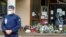 Flowers are stacked outside the school where slain history teacher Samuel Paty was working, in Conflans-Sainte-Honorine, northwest of Paris, France, Oct. 17, 2020.