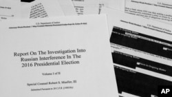 FILE - Special counsel Robert Mueller's redacted report on Russian interference in the 2016 presidential election is photographed in Washington, April 18, 2019.