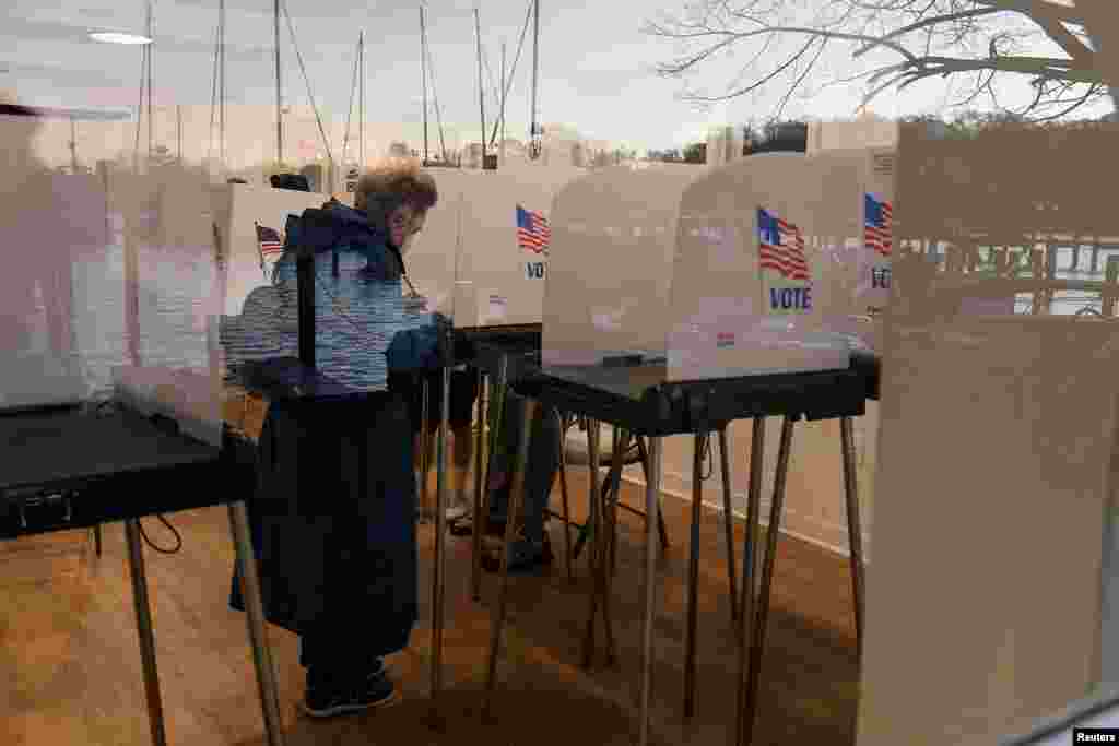 Lake Ogleton is reflected in the window as voters cast their ballots in midterm elections at the Bay Ridge Civic Association, in Annapolis, Maryland, U.S., November 8, 2022. &nbsp;