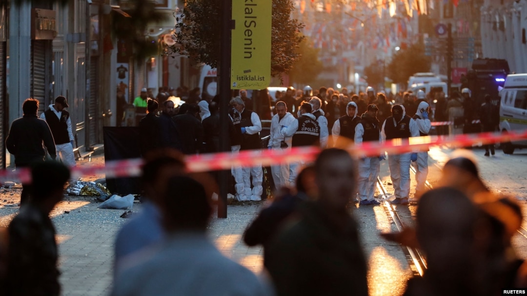 Police and emergency service members work at the scene after an explosion on busy pedestrian Istiklal street in Istanbul, Nov. 13, 2022. 
