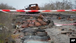 A burnt military car lies by the road after heavy battles between Ukrainian troops and Russian invaders in Mykolayiv region, Ukraine, Nov. 12, 2022.