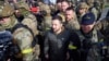 In this photo provided by the Ukrainian Presidential Press Office, surrounded by his guards, Ukrainian President Volodymyr Zelenskyy walks on central square during his visit to Kherson, Ukraine, Nov. 14, 2022.