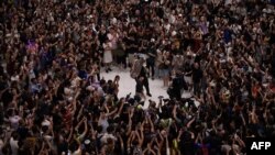 FILE - This file photo taken on September 11, 2019 shows a man playing a tuba as others gather at a shopping mall in the Shatin area of Hong Kong, to sing a recently penned protest song titled 'Glory to Hong Kong."