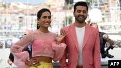 FILE - Actor Alina Khan, left, and director Saim Sadiq attend a photo call for the film "Joyland" at the 75th edition of the Cannes Film Festival in Cannes, southern France, on May 22, 2022. 