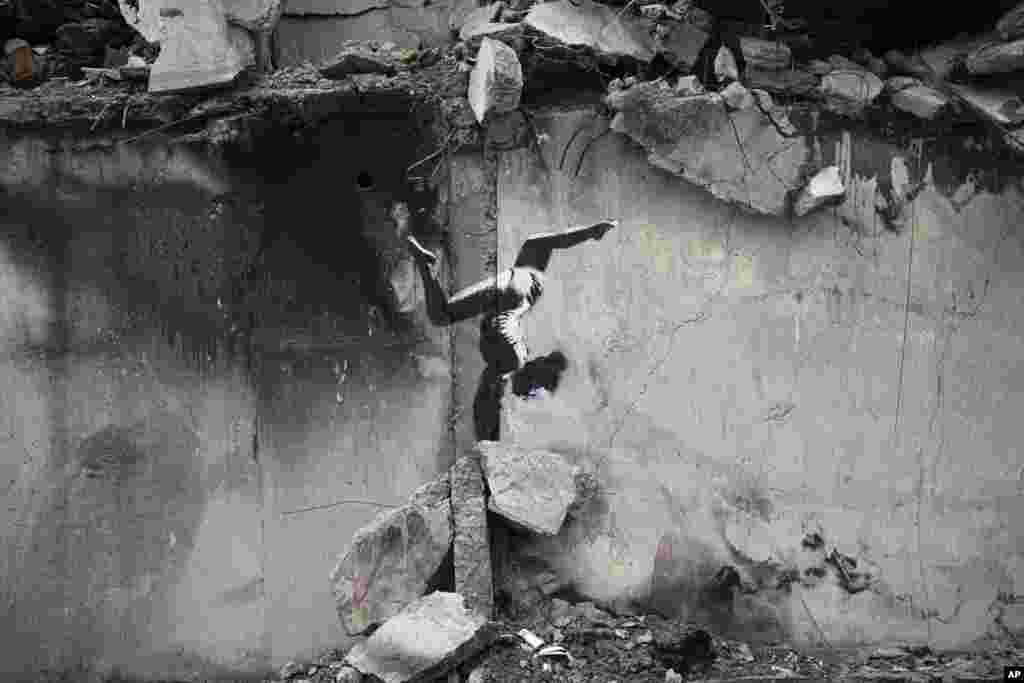 An artwork by British street artist Banksy is seen on a destroyed building in Borodyanka, Kyiv region, Ukraine.