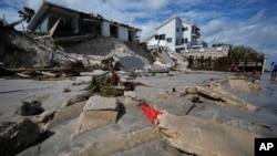 On Nov. 11, 2022, chunks of broken seawall sit in front of a section of Wilbur-by-the-Sea, Florida, homes where Hurricane Nicole eroded the beach while passing through.