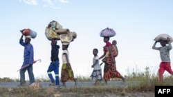 FILE: Displaced families from the community of Impire, a town in the district of Metuge in the Cabo Delgado province, flee on June 14, 2022 armed insurgents who attacked their community on June 12th. (AFP)