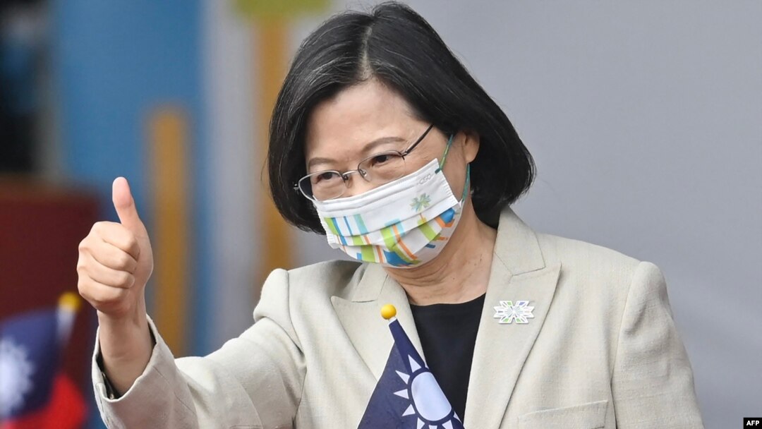 FILE - Taiwan's President Tsai Ing-wen gives a thumbs-up sign as she attends a ceremony to mark the island's National Day in front of the Presidential Office in Taipei on Oct. 10, 2022. 