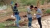 FILE - Researchers studying a malaria outbreak in Dire Dawa, Ethiopia, search for invasive Anopheles stephensi mosquitoes in this undated photo. (Tadele Emiru photo)