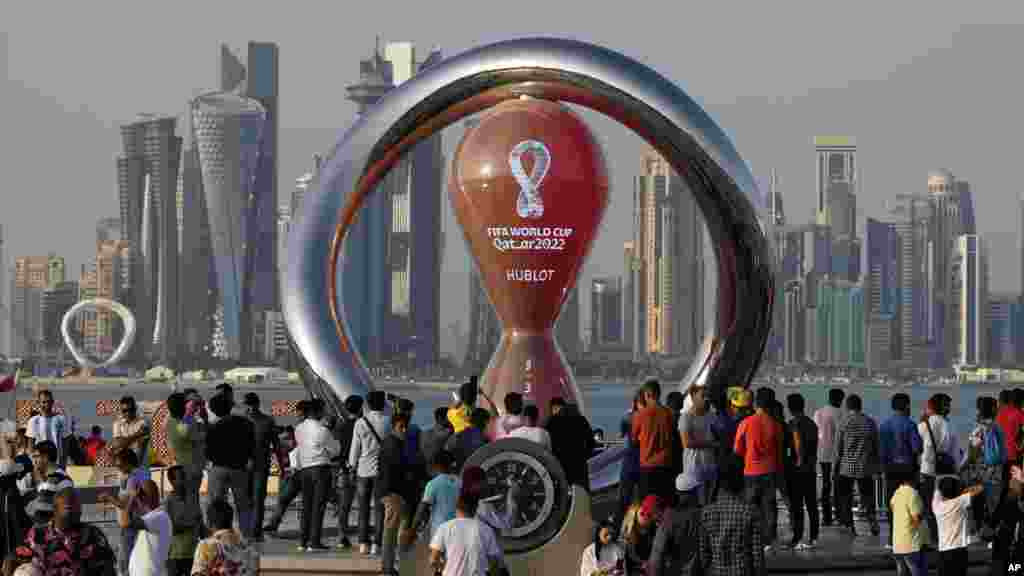 People gather around the official countdown clock showing remaining time until the kick-off of the World Cup 2022, in Doha, Qatar. Final preparations are being made for the soccer World Cup, which starts on Nov. 20 when Qatar faces Ecuador.