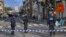 Police officers stand in a cordoned-off area where two of their colleagues were stabbed, in Brussels, Belgium, Nov. 11, 2022. 
