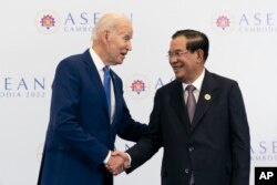 Presiden AS Joe Biden berjabat tangan dengan Perdana Menteri Kamboja Hun Sen sebelum pertemuan mereka selama KTT Perhimpunan Bangsa-Bangsa Asia Tenggara (ASEAN), Sabtu, 12 November 2022, di Phnom Penh, Kamboja. (Foto: AP)