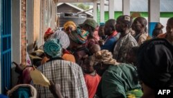 Internally displaced people queue to receive medical attention at a health centre in Kanyaruchinya on November 11, 2022 after taking refuge there while fleeing conflict between the Armed Forces of the Democratic Republic of the Congo and M23 in the territory of Rutsuru, DRC.