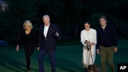 FILE - President Joe Biden and fist lady Jill Biden, left, walk with granddaughter Naomi Biden, second from right, and her fiancé Peter Neal, right, across the South Lawn of the White House in Washington, June 20, 2022. Naomi Biden and Neal wed Nov. 19, 2022, at the White House.