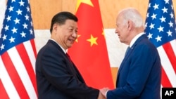 FILE - U.S. President Joe Biden, right, and Chinese President Xi Jinping shake hands before a meeting on the sidelines of the G-20 summit meeting, in Bali, Indonesia, Nov. 14, 2022.