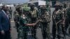 The governor of the North-Kivu Province, General Constant Ndima, third from left, greets Kenyan army troops as they land at Goma airport, eastern Democratic Republic of Congo, Nov. 12, 2022.