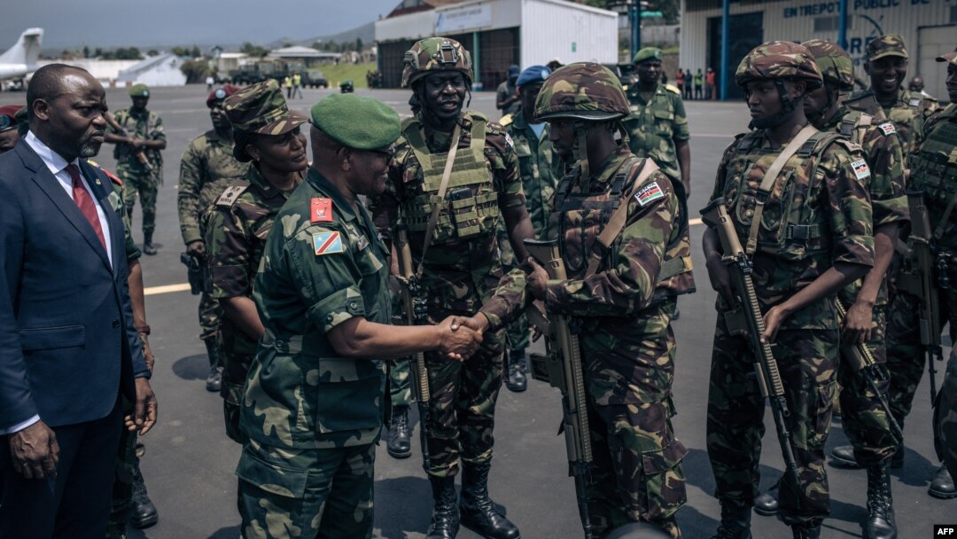 The governor of the North-Kivu Province, General Constant Ndima, third from left, greets Kenyan army troops as they land at Goma airport, eastern Democratic Republic of Congo, Nov. 12, 2022.