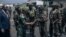 The governor of the North-Kivu Province, General Constant Ndima, third from left, greets Kenyan army troops as they land at Goma airport, eastern Democratic Republic of Congo, Nov. 12, 2022.