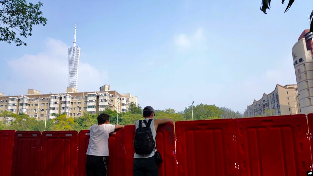 中国广东广州被封的海珠区居民从围栏里向往张望。（2022年11月11日）(photo:VOA)