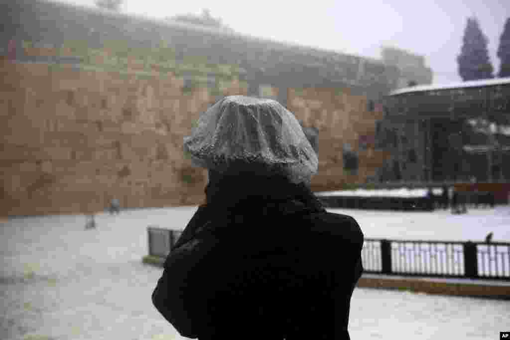 An ultra-Orthodox Jew takes a photograph of the Western Wall, one of the holiest sites where Jews can pray, in Jerusalem, Dec. 12, 2013.